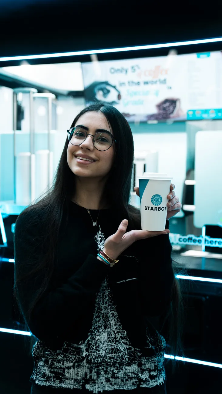 Customer enjoying STARBOT specialty coffee