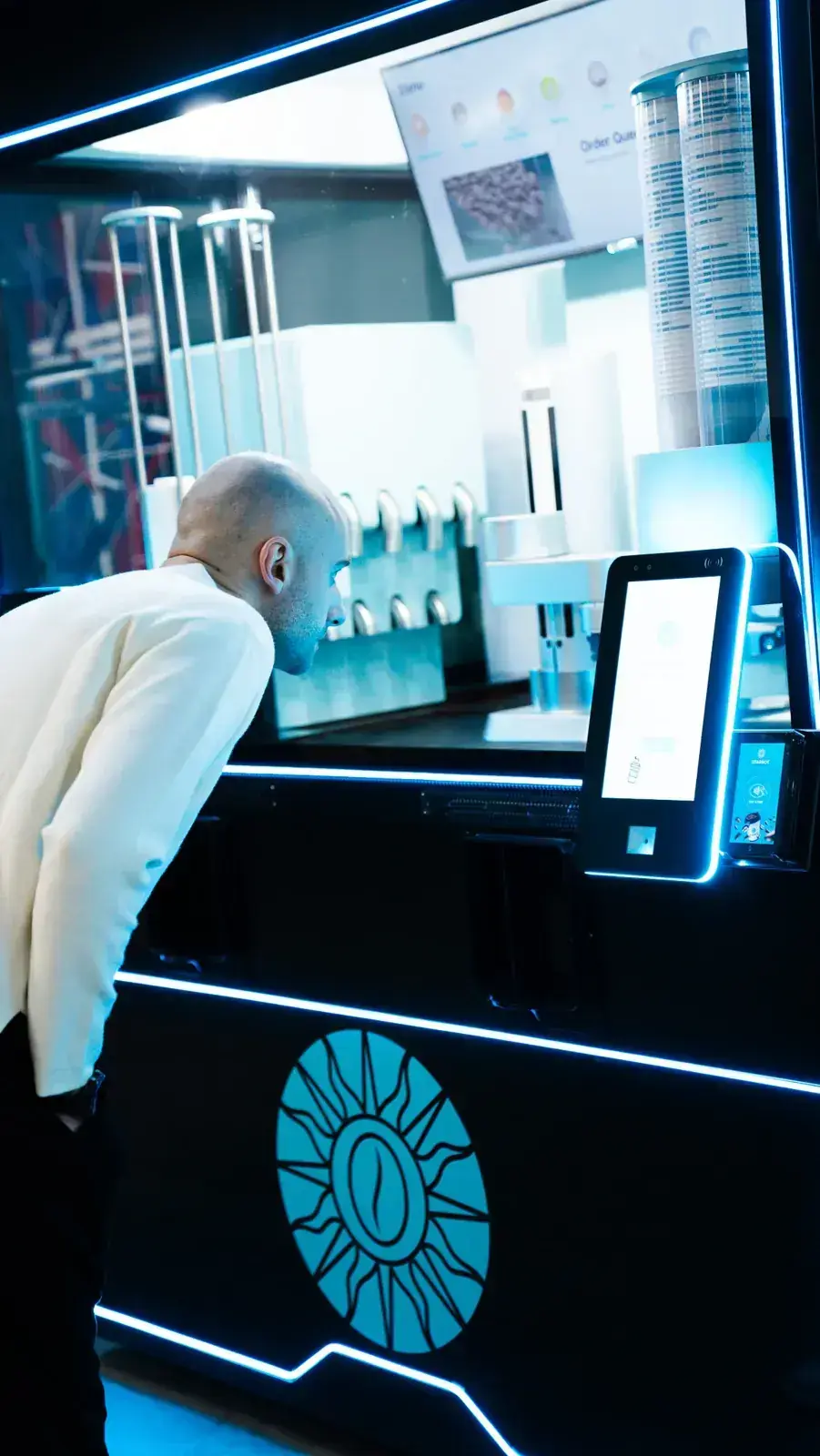A customer ordering coffee at the STARBOT touchscreen